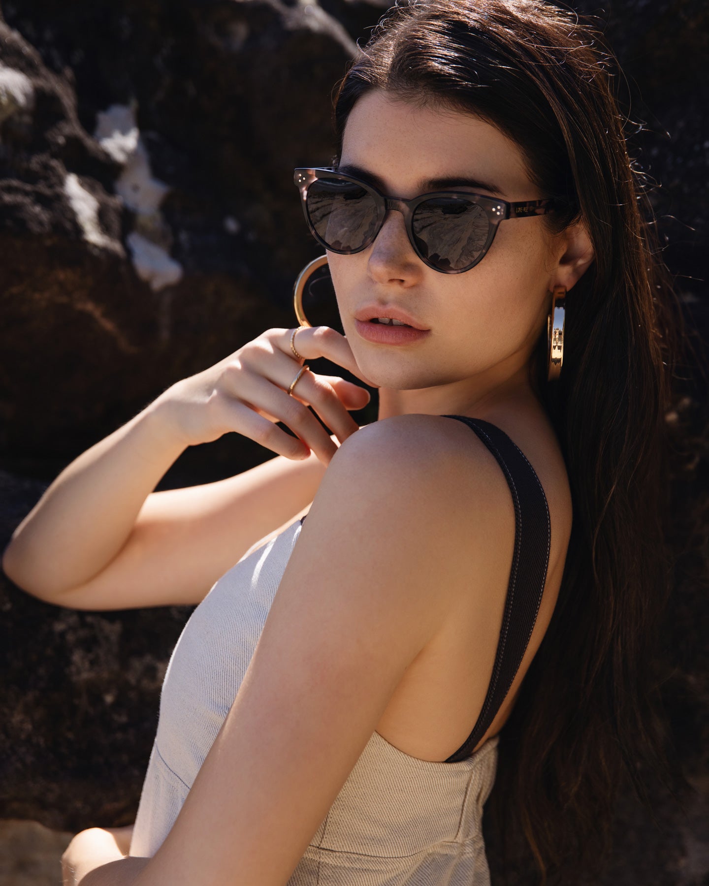 Model Wearing Fashion Sustainable Sunglasses UV400 On Beach With Rocks