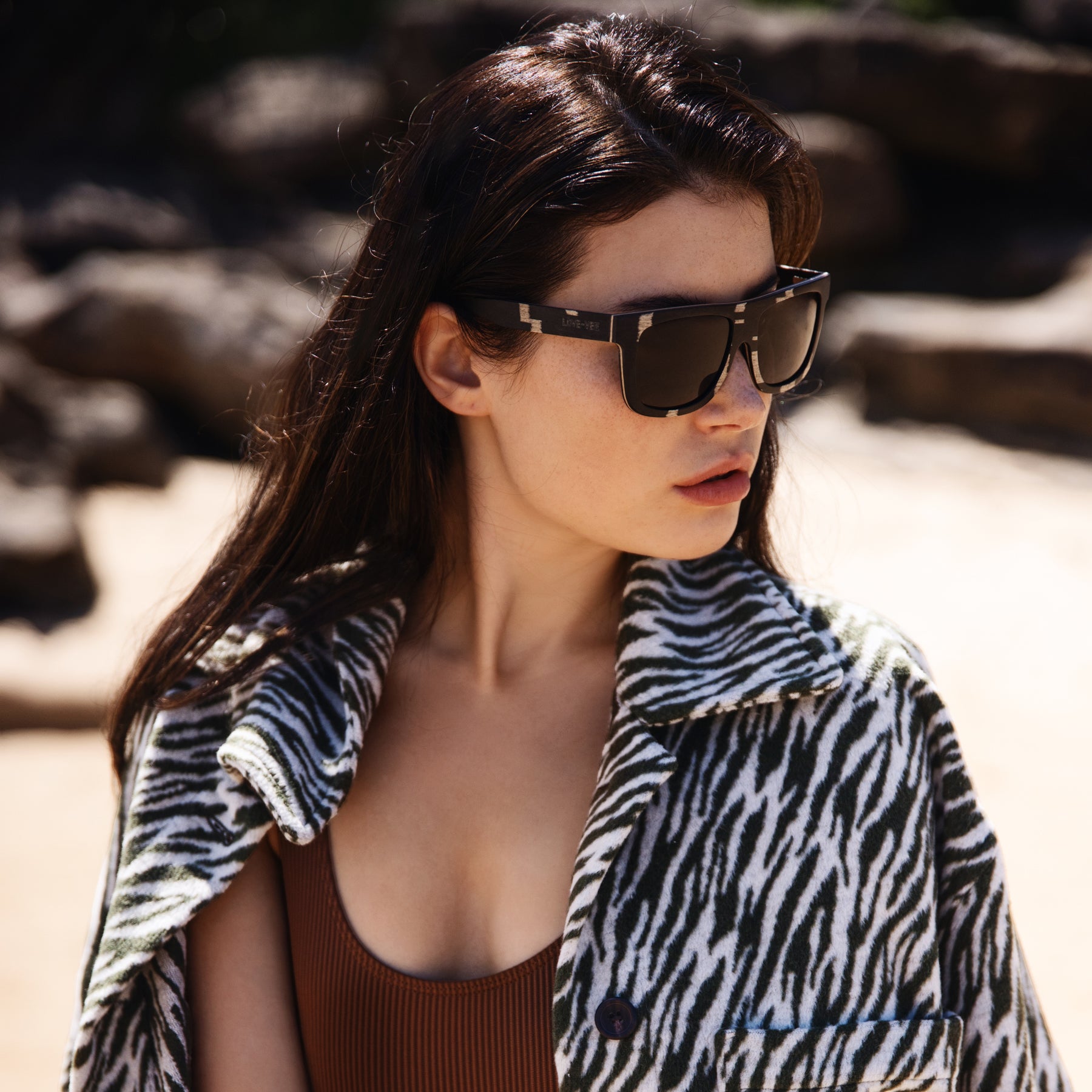  Retro-Squared Black Dot Wood Sunglasses Styled With Green Coat On Beach