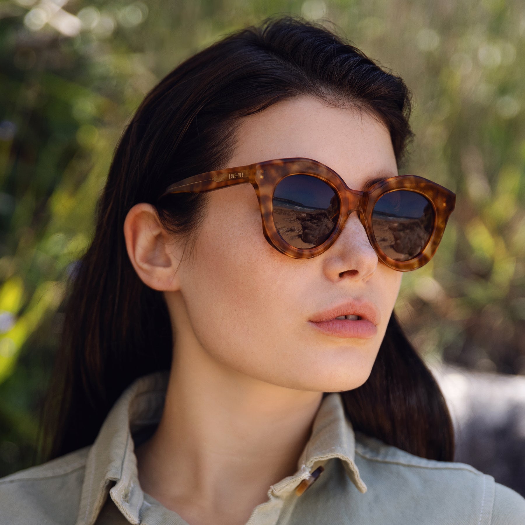 Plant-Based Acetate Intense Tortoiseshell Round Sunglasses Styled On Green Australian Beach