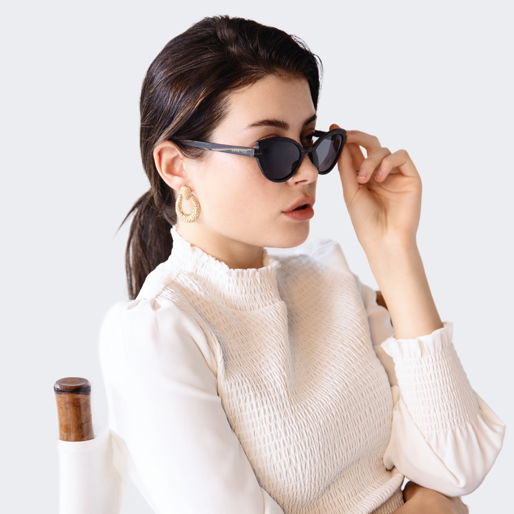 Ebony Black Wood Sunglasses Styled On Studio With Chair